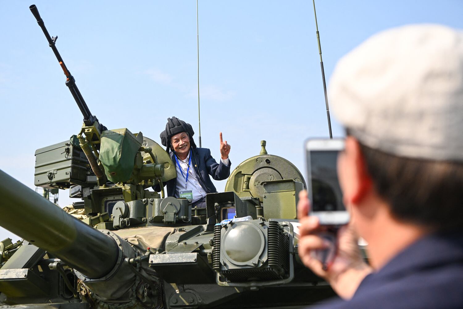 A man poses on top of a Russian-made tank during the Vietnam 2024 International Defense Expo in Hanoi on Dec. 19, 2024.