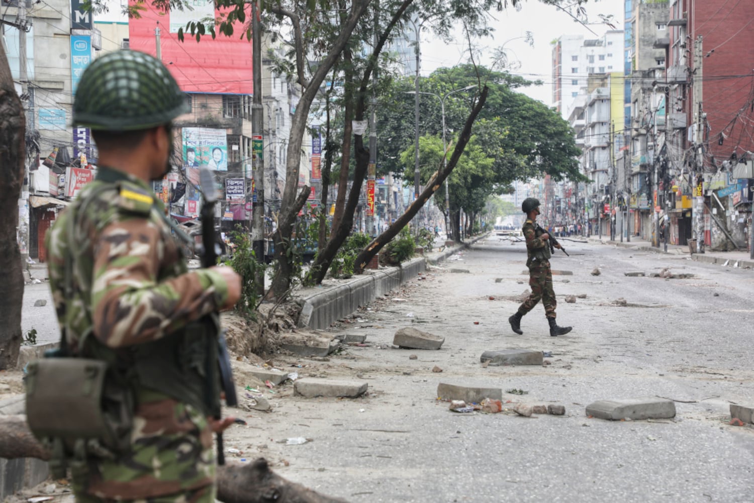 Soldiers walk on a street in the Rampura area of Dhaka on the first full day of a nationwide curfew, July 20, 2024. (Jibon Ahmed/BenarNews)