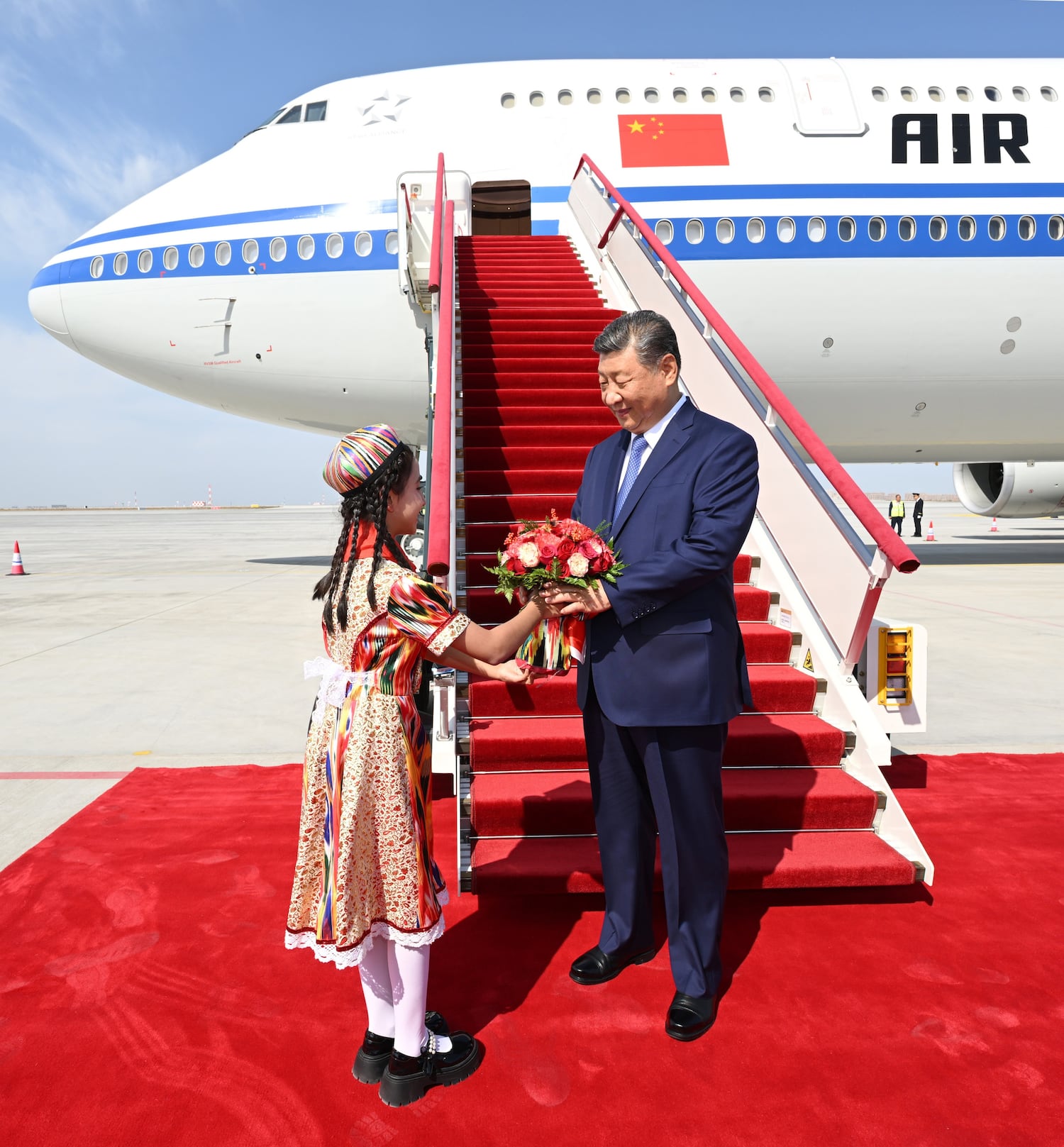 In this Chinese government image that could not be independently verified, President Xi Jinping receives flowers upon his arrival in Urumqi, Xinjiang Uyghur Autonomous Region, Sept. 23, 2025. (Xie Huanchi/Xinhua via Getty Images)