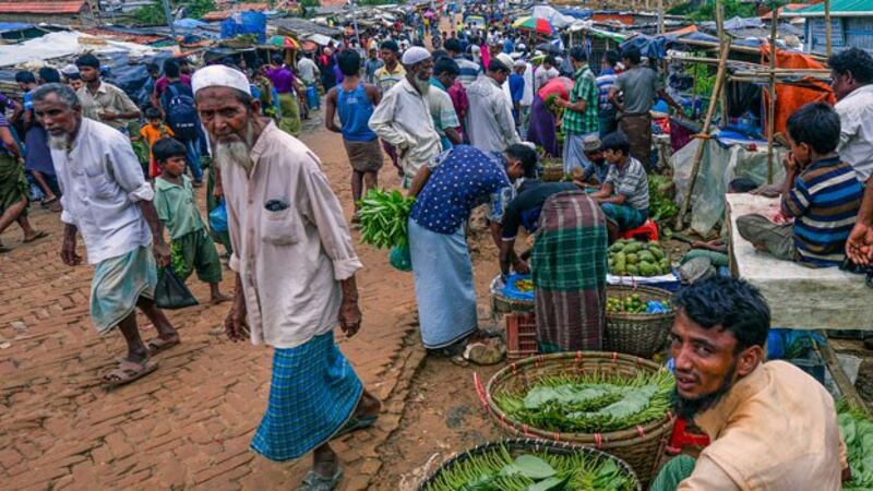 A Rohingya man (R) from Myanmar sells betel leaves at a market at the Kutupalong refugee camp in Ukhia, Cox's Bazar district, southeastern Bangladesh, July 21, 2019.