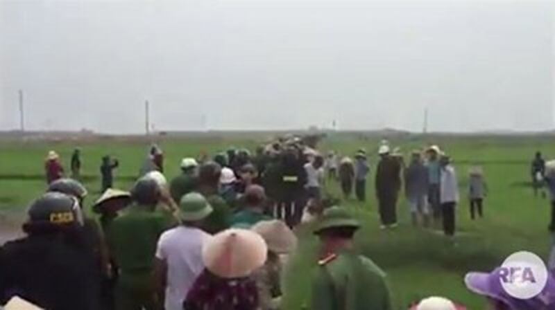 A screen grab from a video posted to Facebook shows security personnel enter Vong Dong hamlet to forcibly evict residents, April 19, 2017.