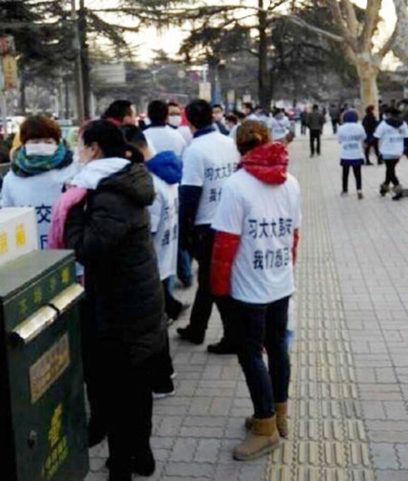 業主身穿寫有"強制交房,利海厲害"的抗議T恤在巿委討說法。（維權人士提供） 