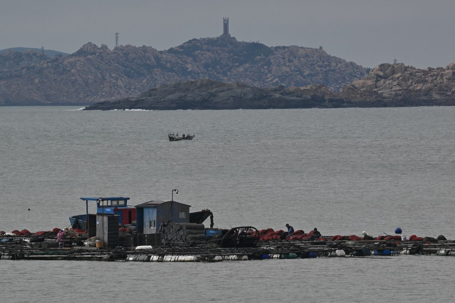 Fishermen work on an aqua farm on Pingtan island, the closest point in China to Taiwan's main island, in southeast China's Fujian province on December 11, 2024.