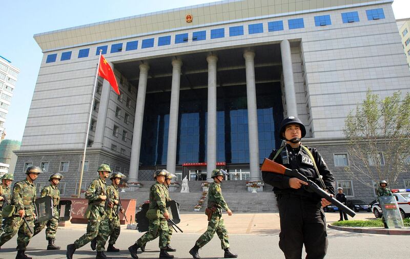 2009 年 9 月 12 日，在新疆地区乌鲁木齐，中国武警在法院大楼外站岗。 （法新社）