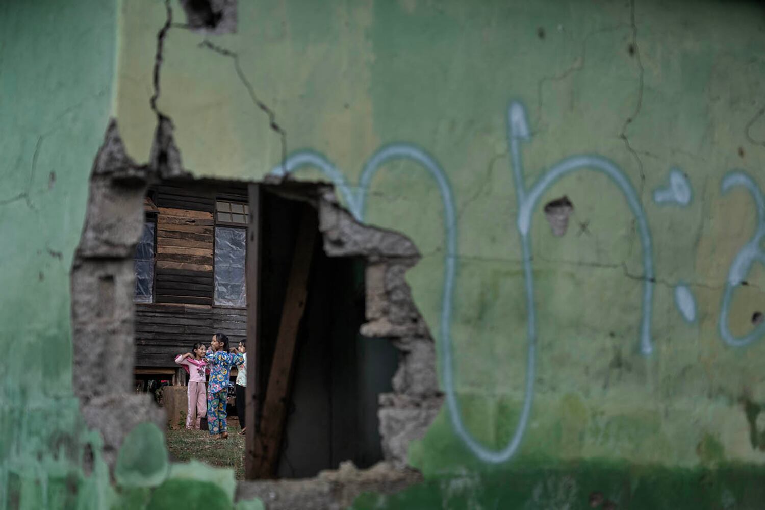Schoolchildren practice a dance near a building damaged by a March 2024 junta airstrike in Lwe Yin town, southern Shan state, Myanmar, Oct. 28, 2024.
