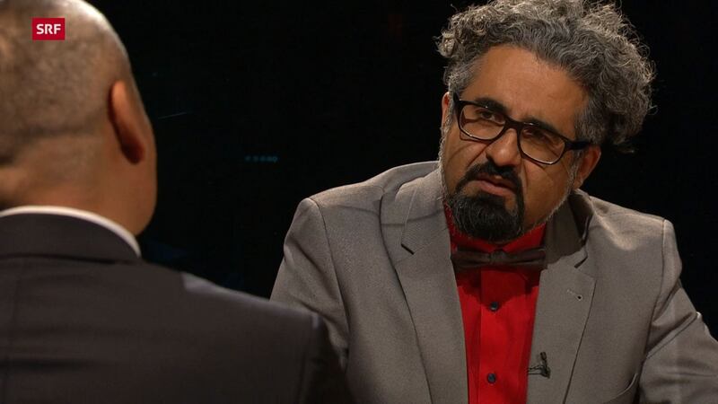 شىۋېتسارىيەنىڭ دۆلەت قانىلى سرف دا ئۇيغۇرلار توغرىسىدا تارقىتىلغان «بىر مىللەتنىڭ كۆرۈنمەس ئازاب-ئوقۇبەتلىرى» ناملىق سۆھبەت پروگراممىسىدا رىياسەتچى ئەھمەد مىلاد(Ahmad Milad Karimi) ئەپەندى سوئال سورىماقتا. 2022-يىلى 15-يانۋار.