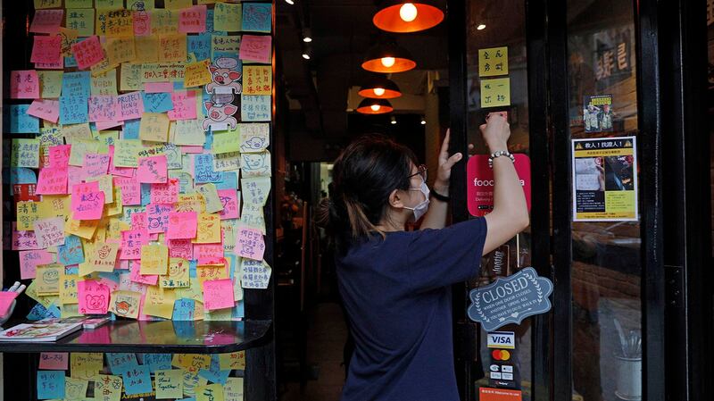 2020年7月2日，香港国安法通过之后，香港工人在清除街头的抗议标语。（美联社）