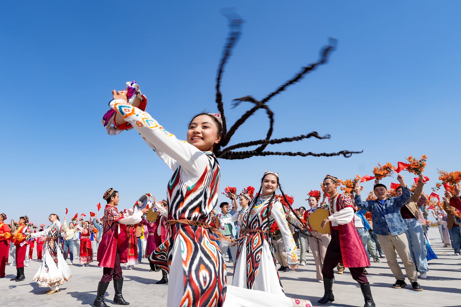 In this Chinese government image that could not be independently verified, performers welcome President Xi Jinping in Urumqi, Xinjiang Uyghur Autonomous Region, Sept. 23, 2025. (Bi Xiaoyang/Xinhua via Getty Images)