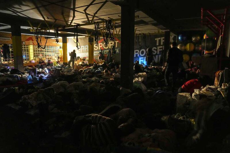 People prepare for the night in an improvised bomb shelter in a sports center in Mariupol, Ukraine, late Sunday, Feb. 27, 2022. (Associated Press)