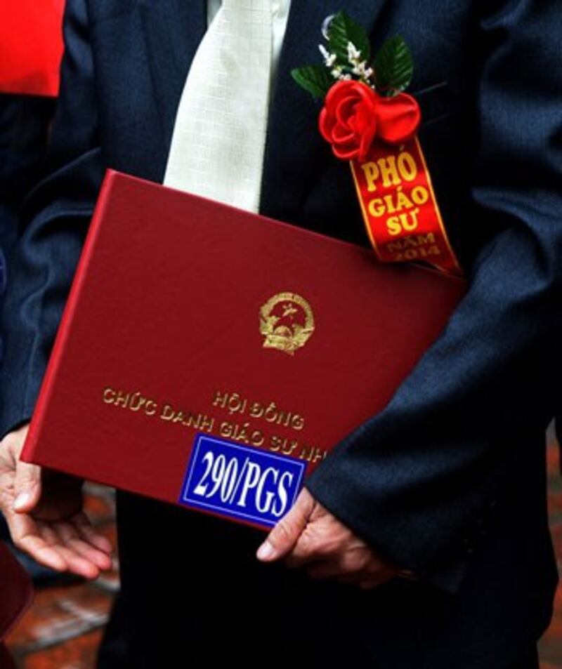 Một giảng viên với giấy chứng nhận chức giáo sư được cấp hôm 4/2/2015. AFP photo