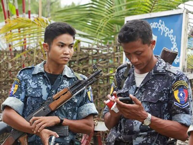 Armed border police stand guard in Maungdaw township, western Myanmar's Rakhine state, Oct. 10, 2016.