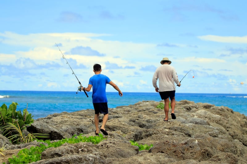 Residents go fishing near Tumon beach on the island of Guam on Aug. 11, 2017.