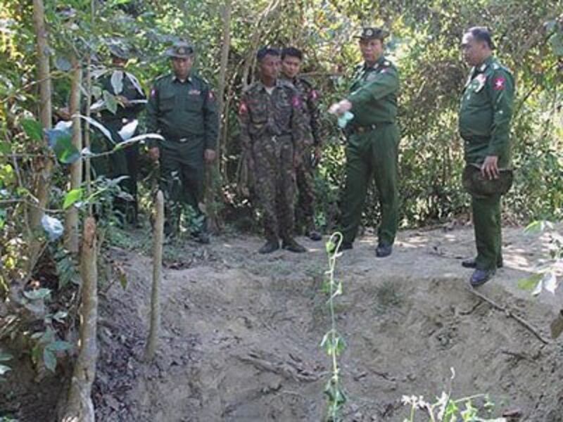A Myanmar military investigation team examines a mass grave where soldiers buried Rohingya Muslims they killed in Inn Din village, Maungdaw township, western Myanmar's Rakhine state, in an undated photo.