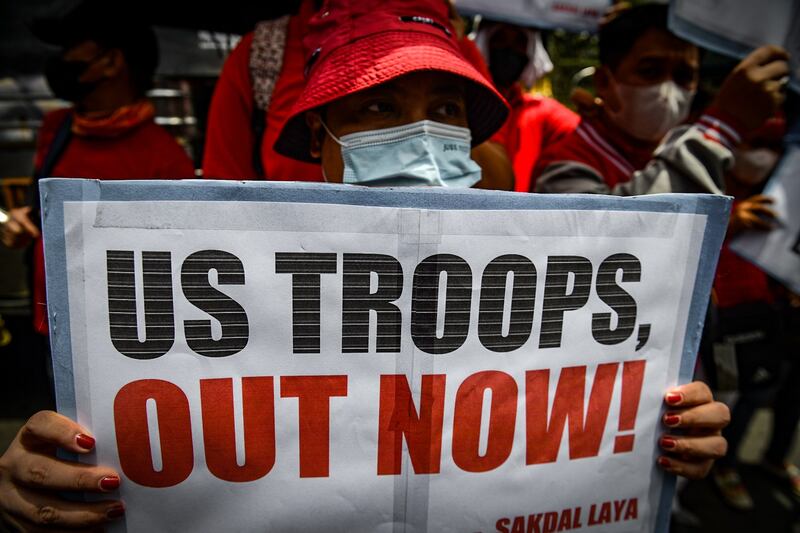 Protesters denounce an Enhanced Defense Cooperation Agreement that allows U.S. forces to use Philippine military sites, during a May Day demonstration outside the American embassy in Manila, May 1, 2023. Credit: Jojo Riñoza/BenarNews