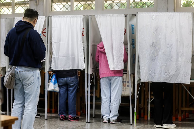 Voters cast their ballot for the presidential election at a polling station in Taipei on Jan. 13, 2024.