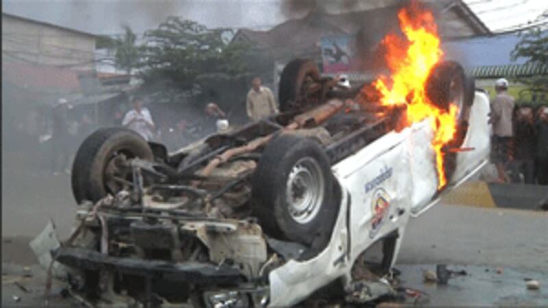 A burning police car in Phnom Penh, July 28, 2013.