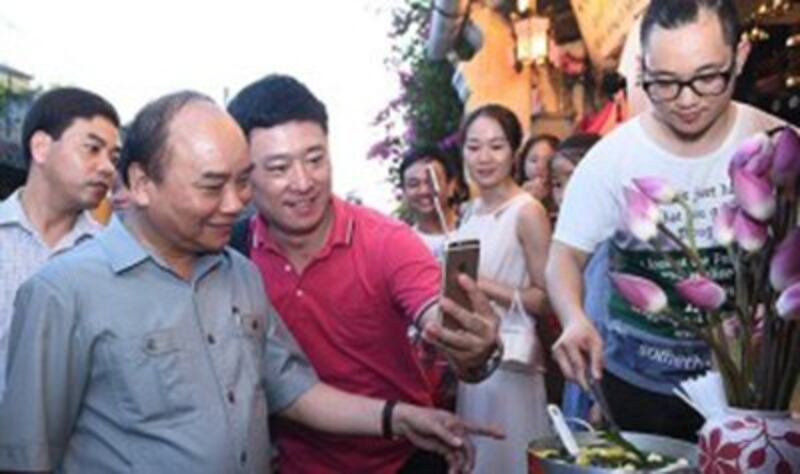 Người dân chụp hình selfie cùng thủ tướng ở Phố cổ Hội An.