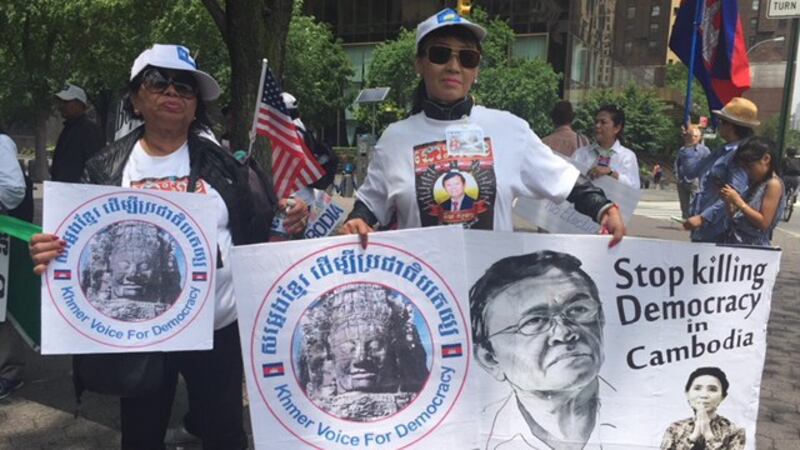 CNRP supporters hold signs the decline of democracy in Cambodia, in New York City, June 1, 2018. Credit: RFA