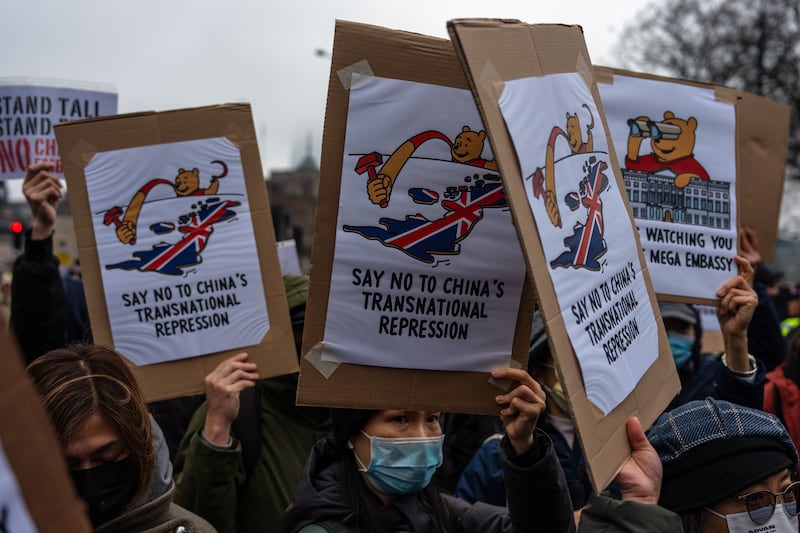 Protesters hold placards as they demonstrate at the proposed site of China's embassy, Feb. 8, 2025 in London.