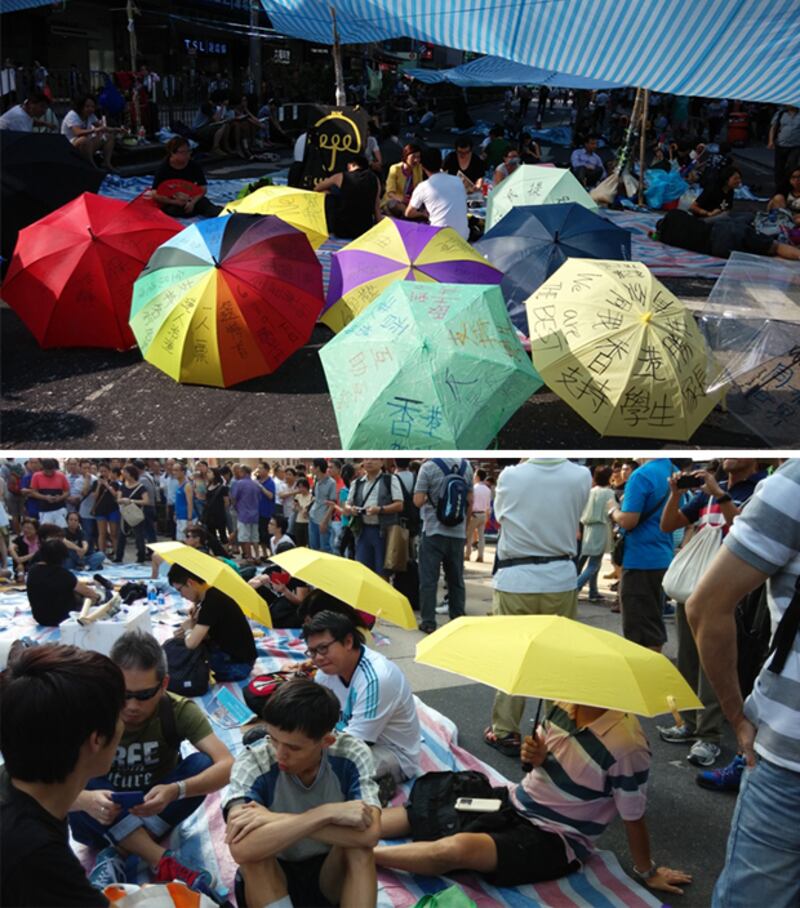 2014年10月6日,旺角示威現場有多把寫上標語的雨傘。有示威者打開黃色雨傘。(姬勵思拍攝)