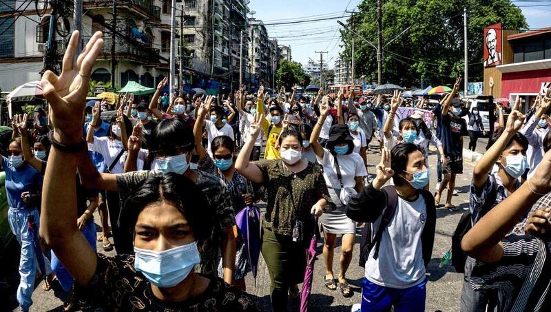 Protesters make the three-finger salute during a demonstration against the military coup in Yangon. (AFP)