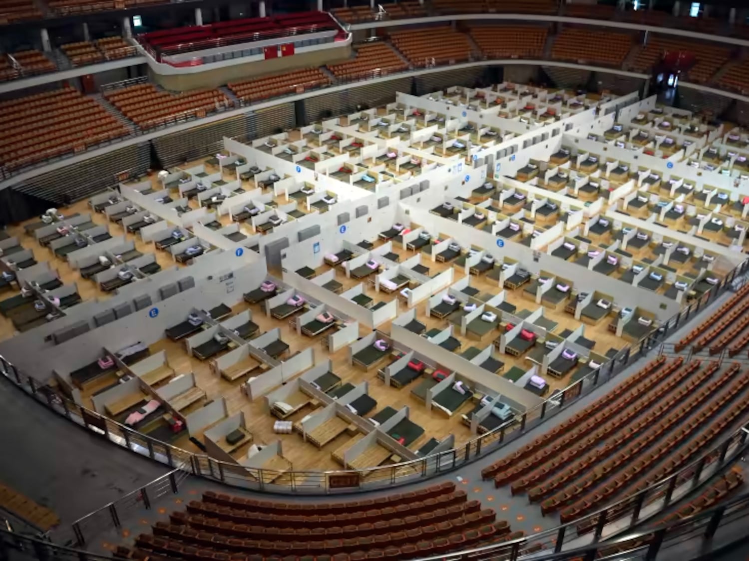 Rows of beds lie waiting to be filled at a makeshift hospital set up in the Wuhan Sports Center stadium, Wuhan, China, Feb. 12, 2020.