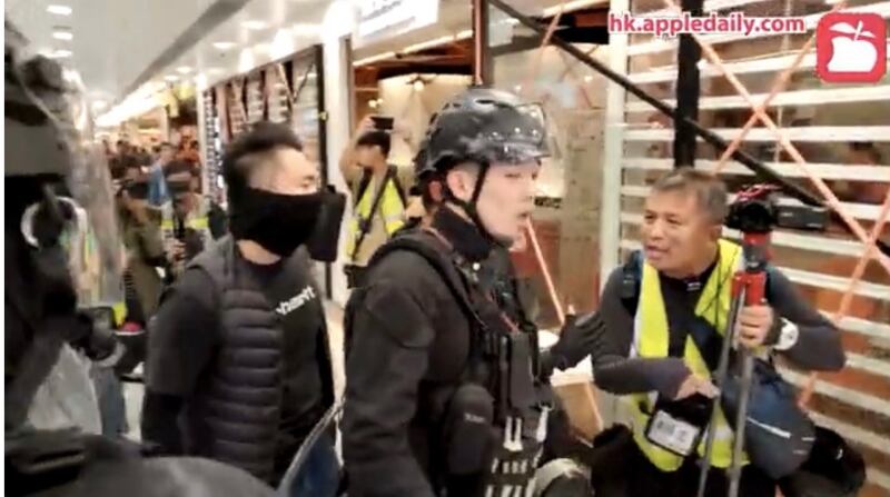 去年12月底,《立場新聞》記者陳郎昇(右)在大埔採訪示威中被警員截停索取身分證。(香港《蘋果日報》直播截圖)