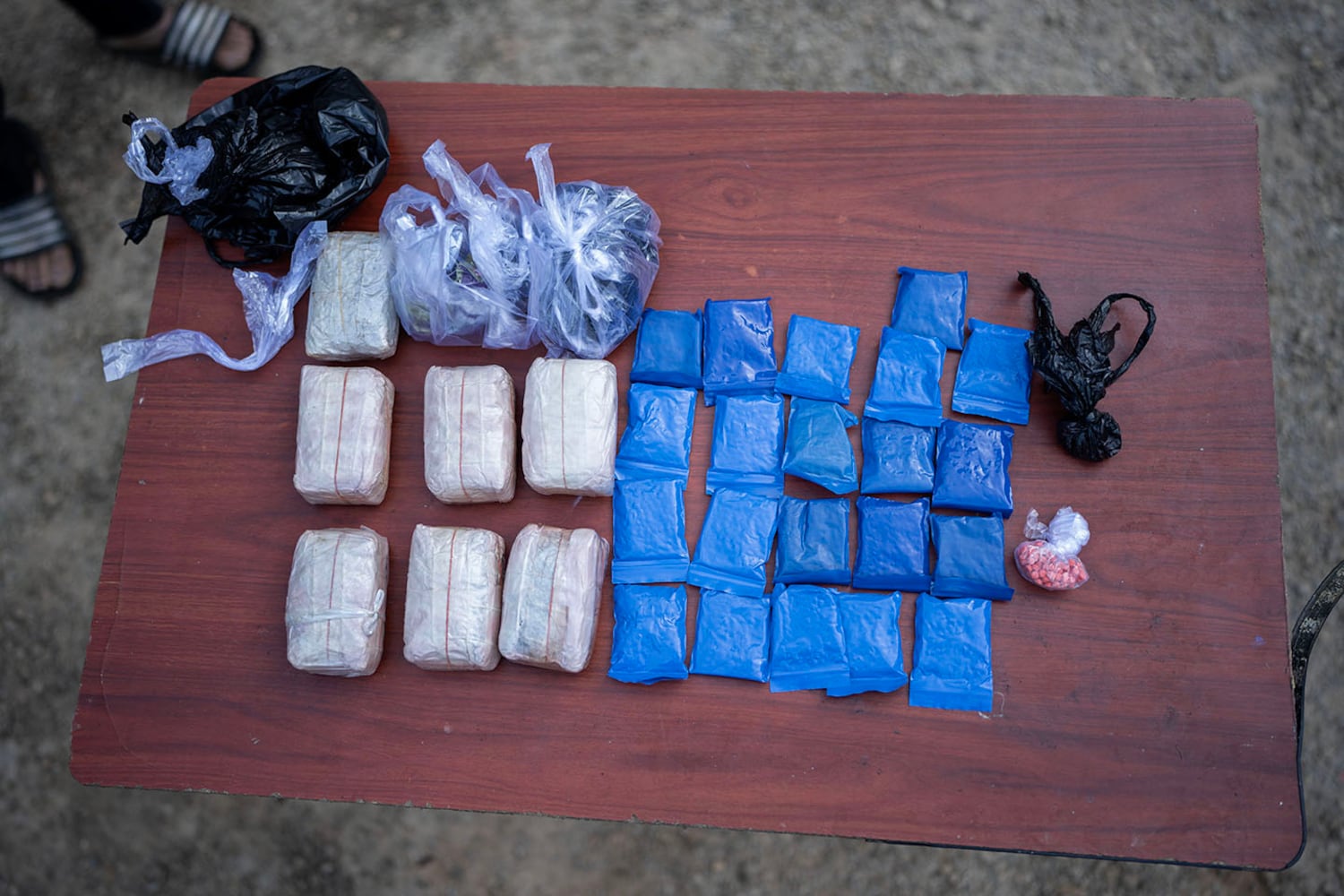 Bags of illicit drugs, including a mixture of methamphetamine and caffeine known as yaba, lie on a table at KSP Station 8 in southern Shan state, Myanmar, Nov. 4, 2024.