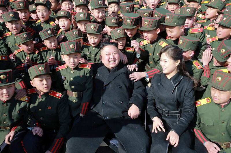 Kim Jong Un (C) and his wife Ri Sol-Ju (front 2nd R) visit the Mangyongdae Revolutionary School in Pyongyang to plant trees with its students on Tree Planting Day, March 2, 2017. (AFP/KCNA via KNS)