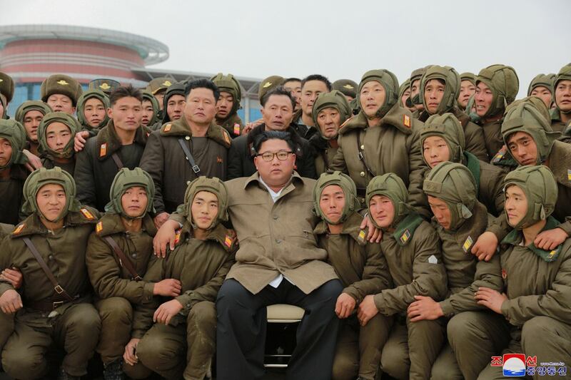 Kim Jong Un poses with members of the Air and Anti-Aircraft Force in North Korea in this picture released Nov. 17, 2019. (KCNA via Reuters)