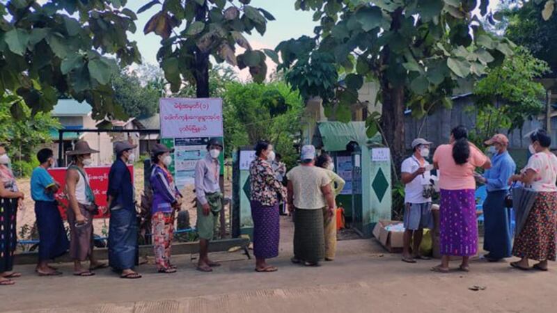 Myanmar voters wait in line outside a village polling station in Pathein township, Ayeyarwady region, Nov. 8, 2020.