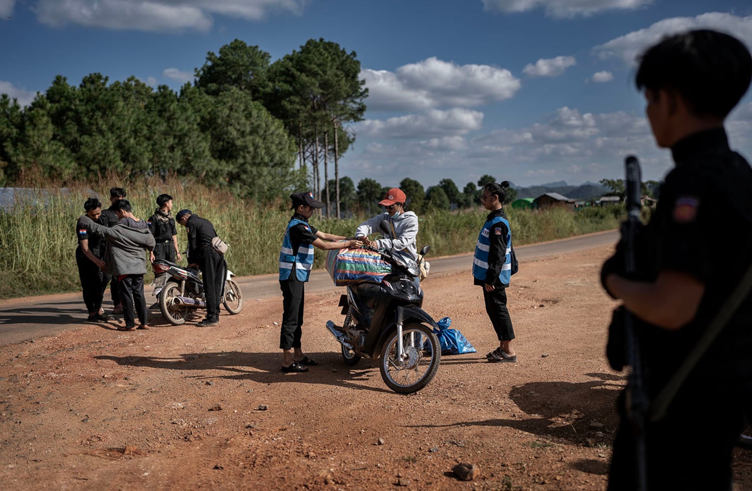 Officers from KSP Station 8 examine travelers at a checkpoint in southern Shan state, Myanmar, Nov. 4, 2024.