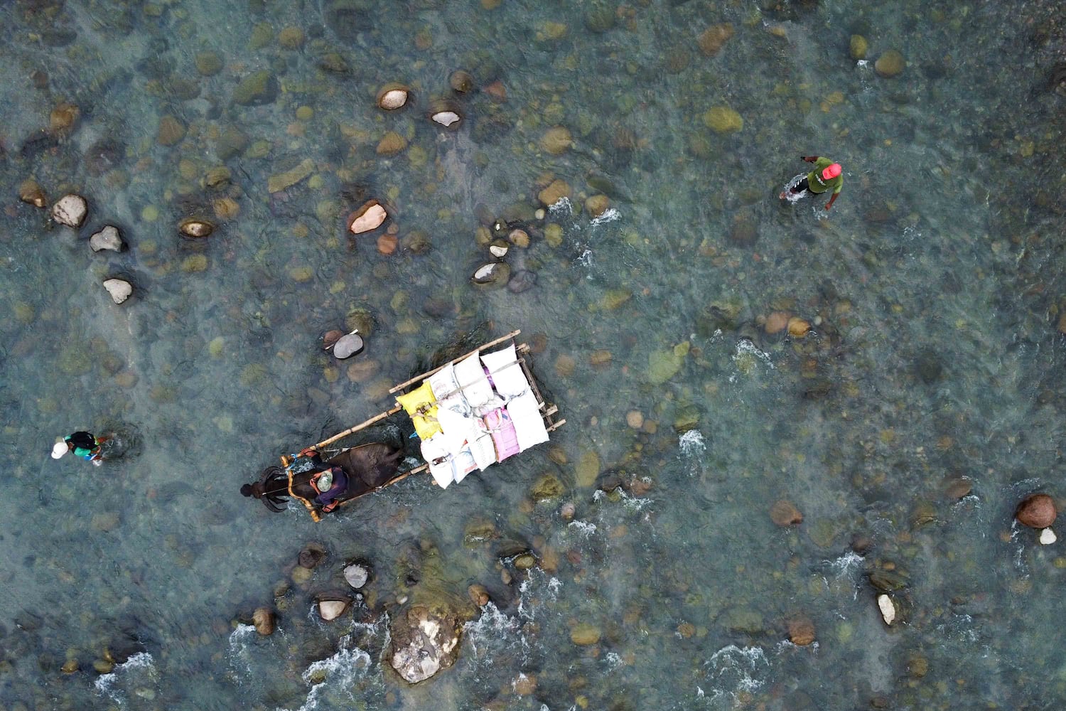 Residents cross the Bangot River, a vital source of livelihood for the indigenous Aeta near Capas, Tarlac, Philippines, Sept. 15, 2026