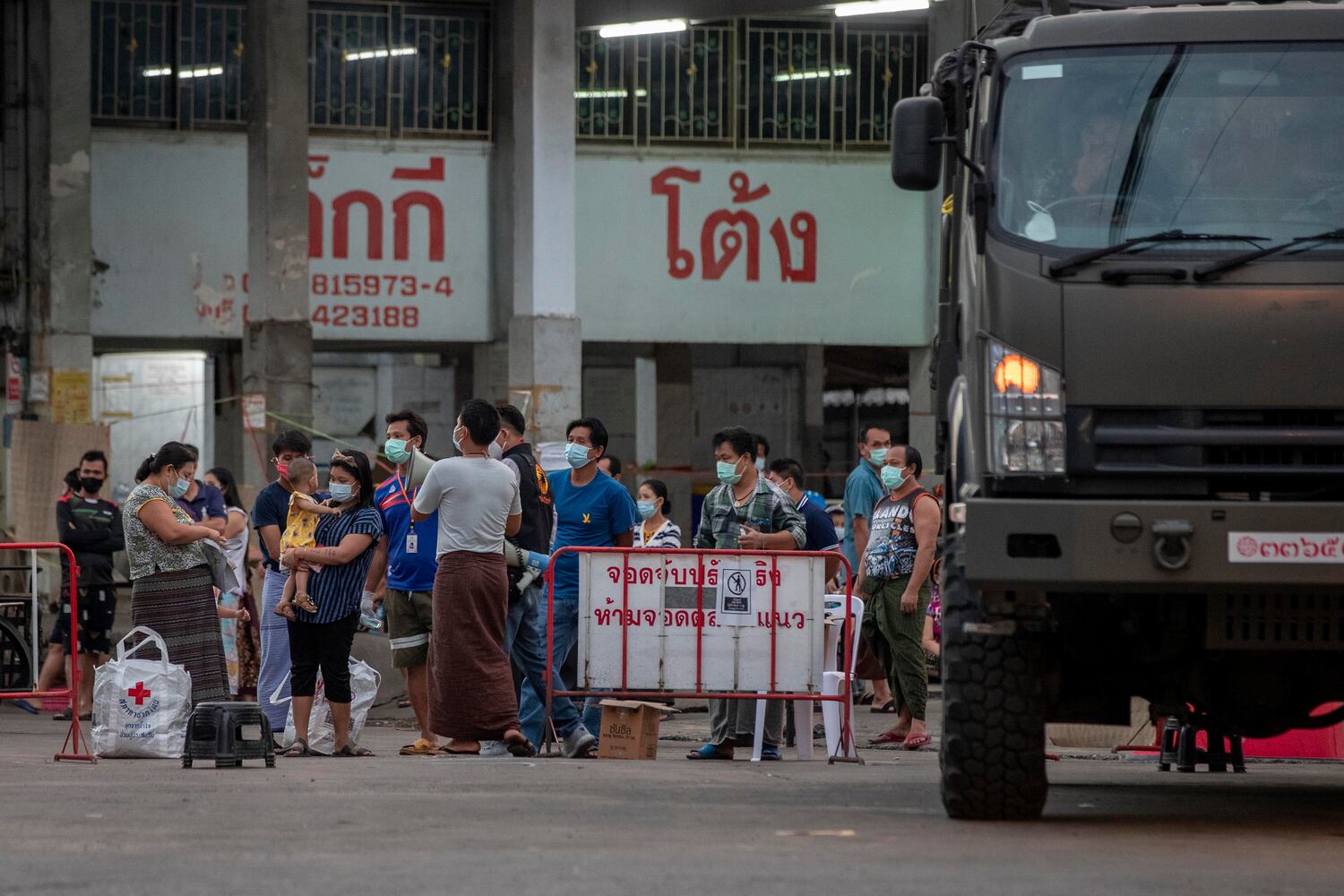 Migrant workers and their families are prepared to be taken to a field hospital for COVID-19 patients in Samut Sakhon, south of Bangkok, Thailand, Jan. 4, 2021.