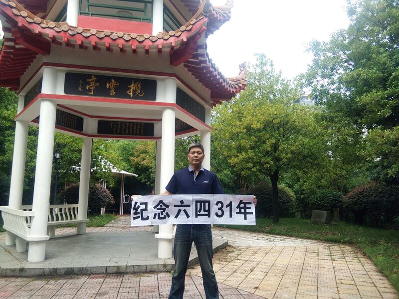 2020年6月5日,湖南异议人士陈思明在株洲拦云亭举牌纪念六四。(陈思明微信)