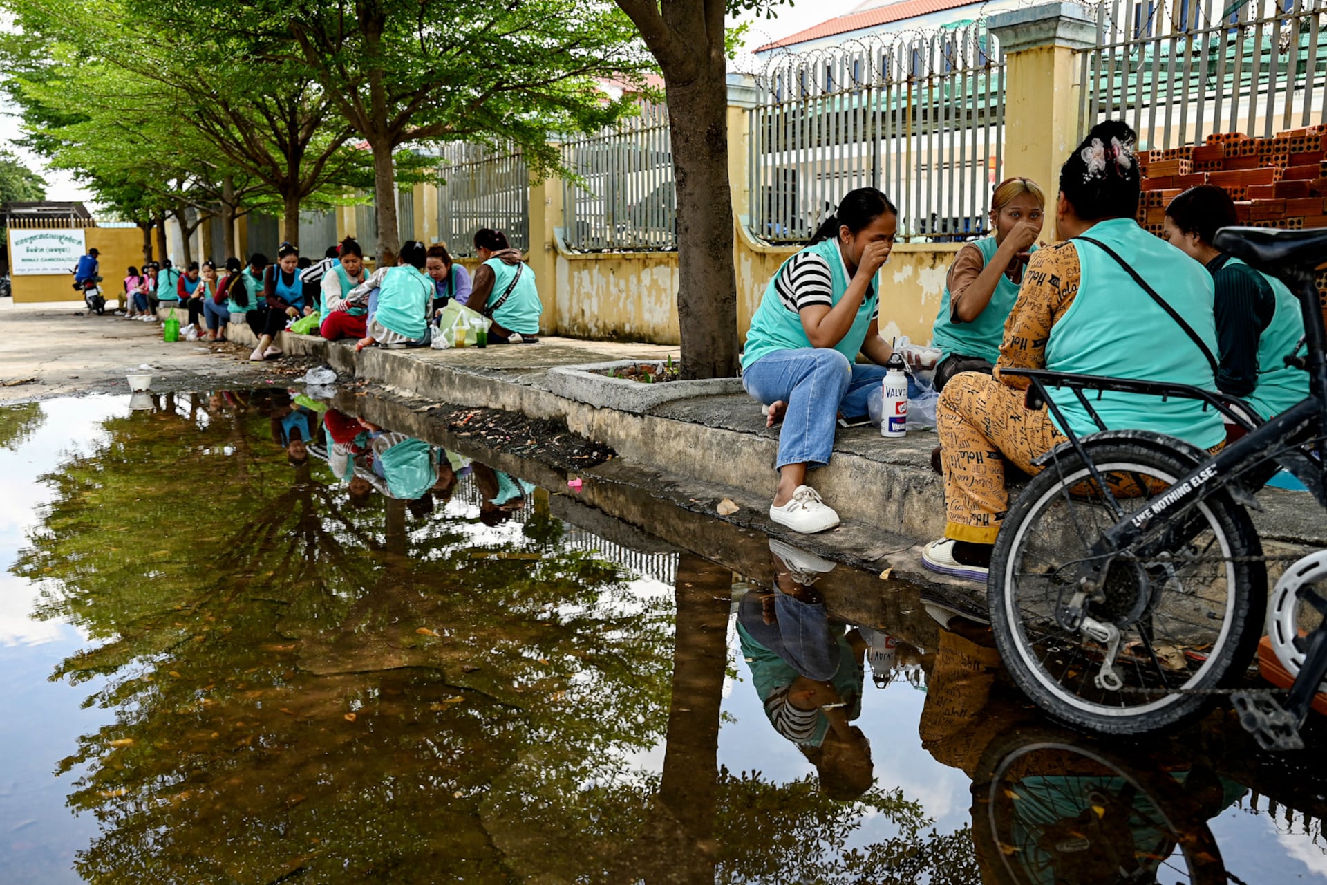 Garment worker have lunch outside a factory in Phnom Penh