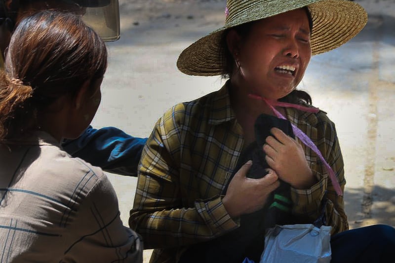Relatives grieve outside of a destroyed pre-school as they collect children's belongings in Sagaing city, Myanmar, on April 24, 2025, four weeks after Myanmar's devastating earthquake.