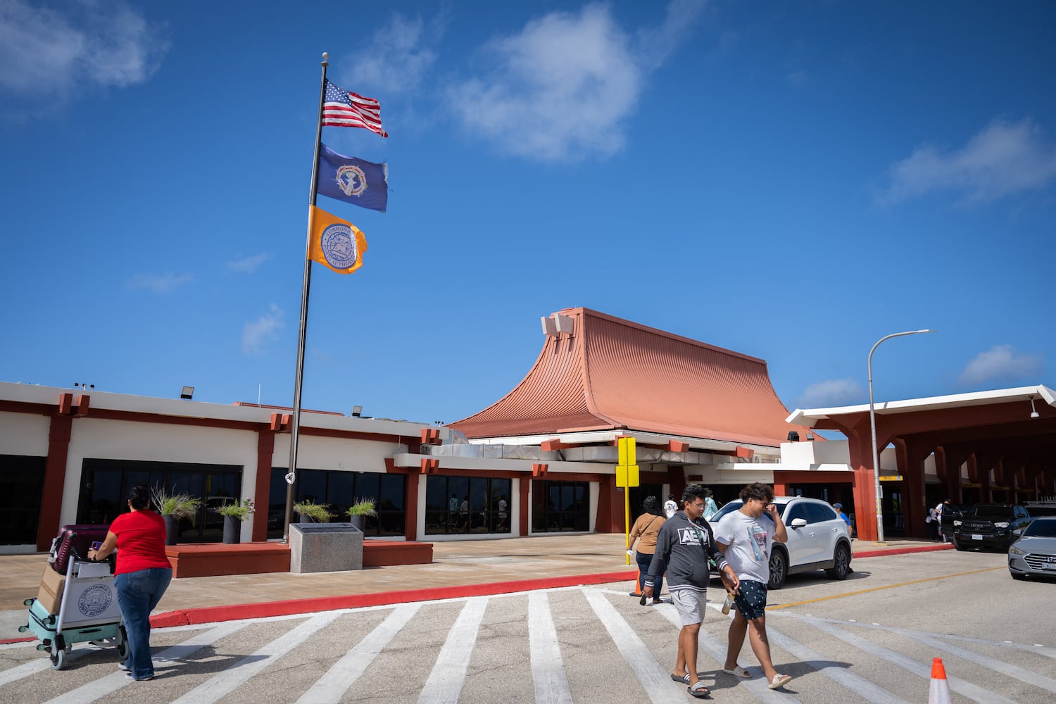 People walk outside of Saipan International Airport in Saipan, Northern Mariana Islands, June 28, 2024
