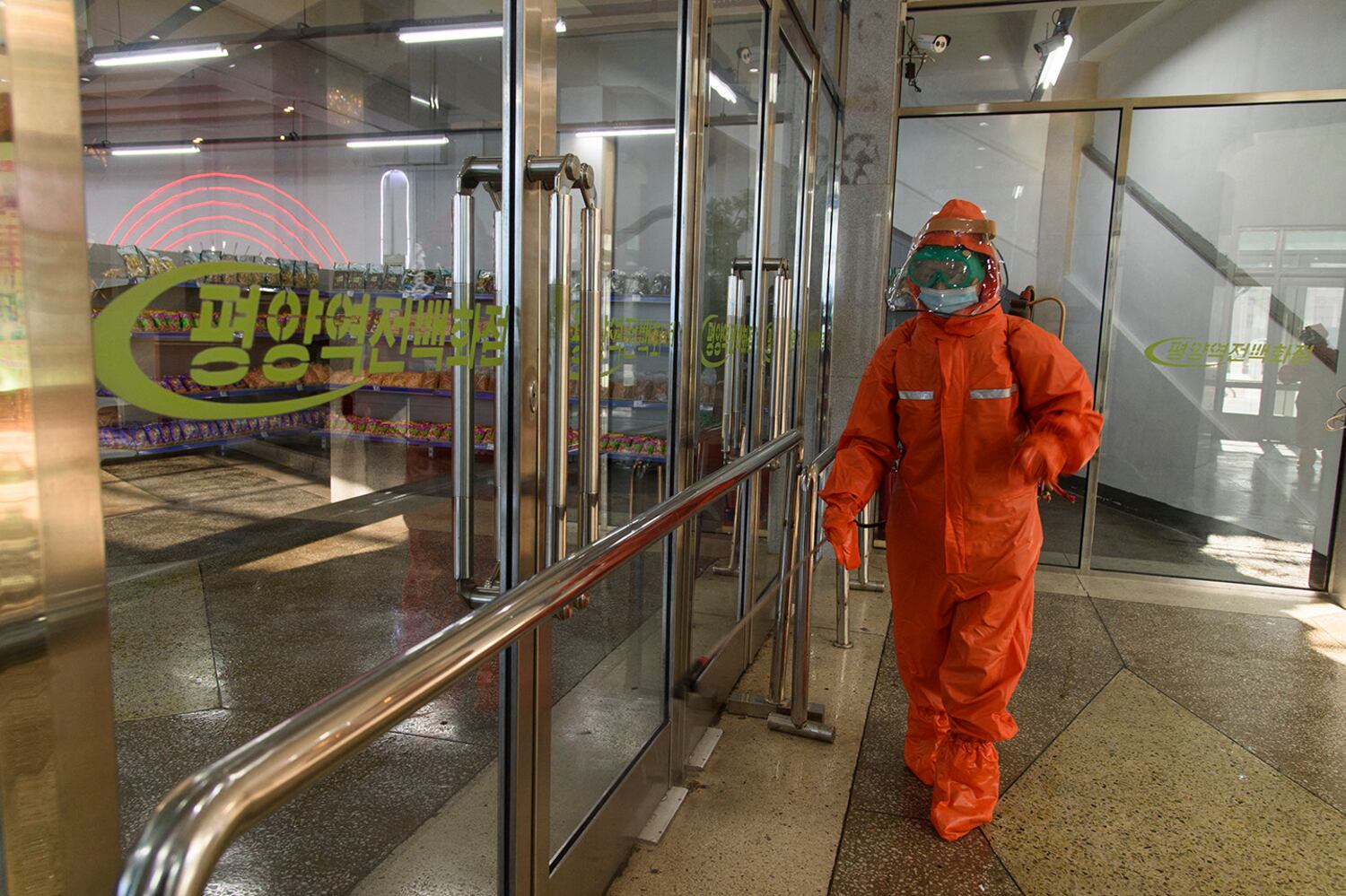 North Koreans use emergency protective gear as raincoats