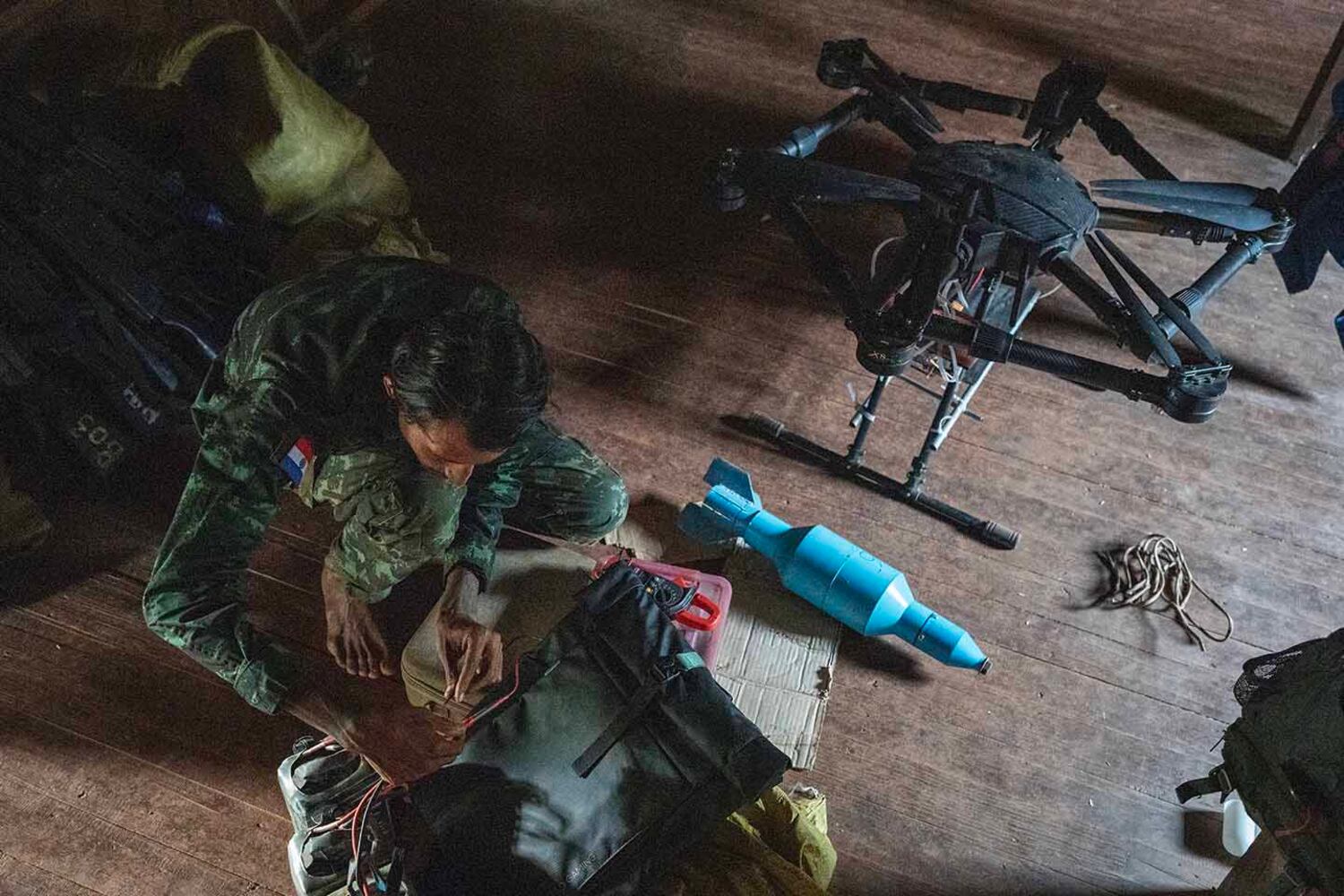KNDF drone pilot Aaron Kyawsey checks his drones as KNDF Battalion 31 prepares to withdraw from Shwephyaya village in southern Shan state, Myanmar, Oct. 31, 2024.