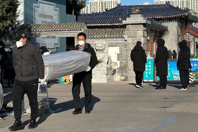 two Beijing men carried coffins outside the crematorium.jpg
