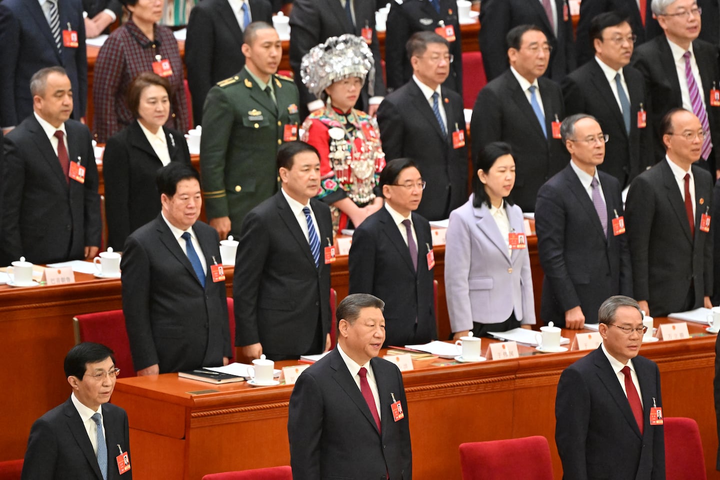 China's President Xi Jinping sings the national anthem during the opening session of the National People's Congress at the Great Hall of the People in Beijing on March 5, 2025.