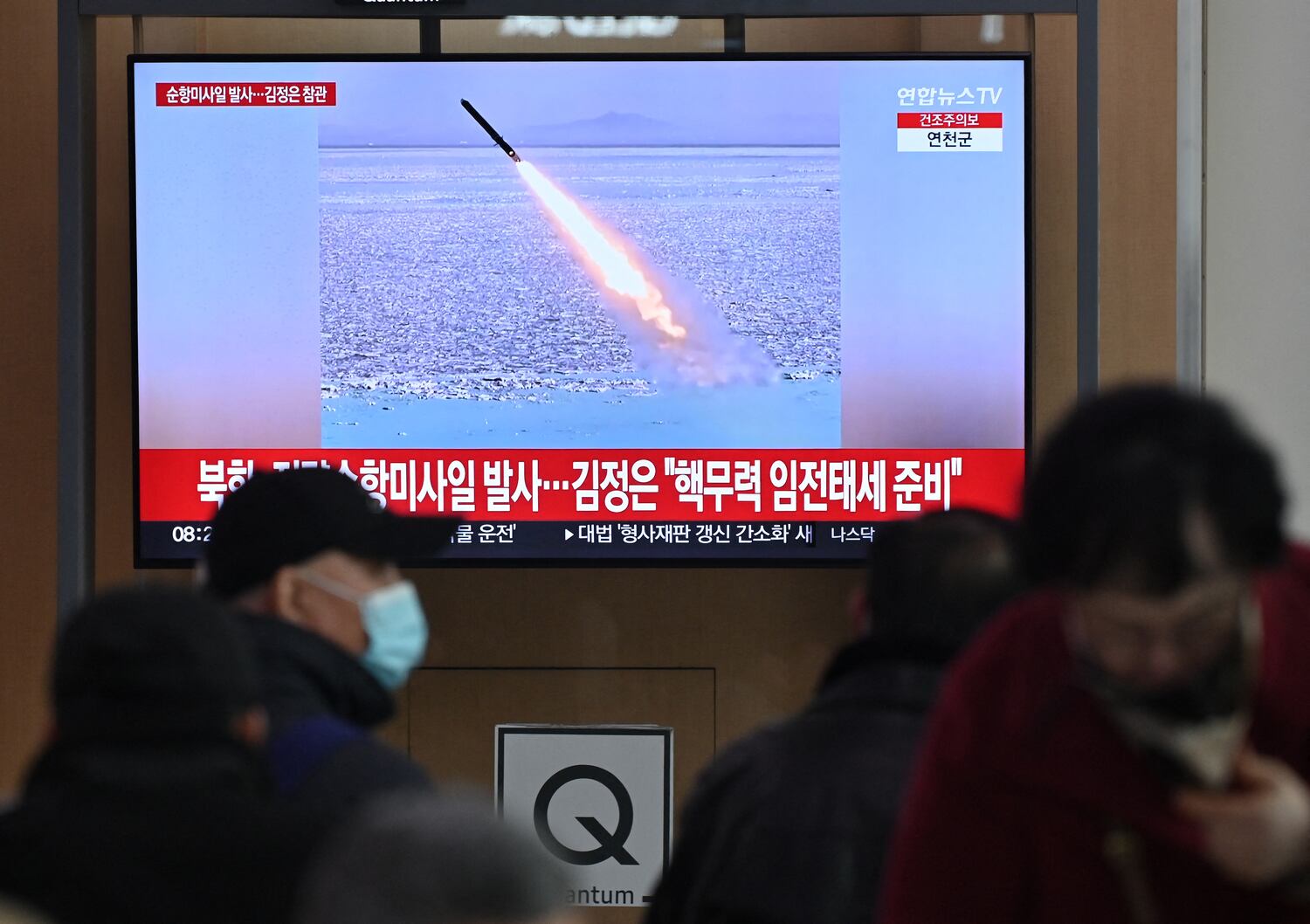 People watch a television screen showing news footage of North Korea's latest test-launch of strategic cruise missiles, at a train station in Seoul on Feb. 28, 2025.