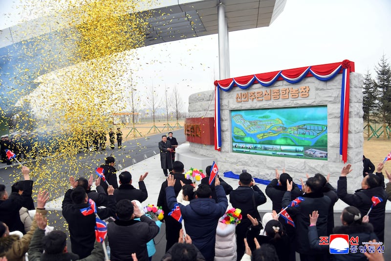 This picture taken on February 1, 2026 and released by North Korea's official Korean Central News Agency, shows North Korean leader Kim Jong Un unveiling a commemorative monument at the inauguration ceremony of the Sinuiju Greenhouse Farm Complex in North Pyongan Province, North Korea.