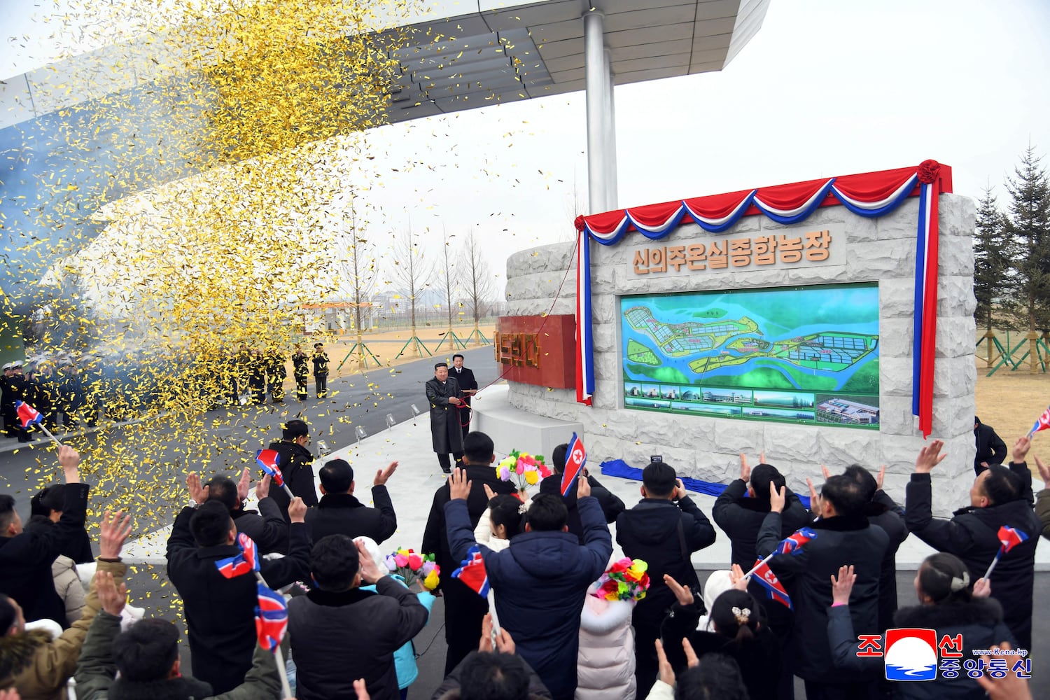 This picture taken on February 1, 2026 and released by North Korea's official Korean Central News Agency, shows North Korean leader Kim Jong Un unveiling a commemorative monument at the inauguration ceremony of the Sinuiju Greenhouse Farm Complex in North Pyongan Province, North Korea.