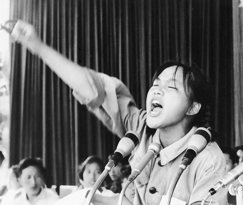 1966年8月10日，这位仅知姓周的女青年，在北京天安门广场鼓舞其他红卫兵同志的士气。中共党中央在1966年5月16日正式启动了文化大革命。(美联社资料图片)