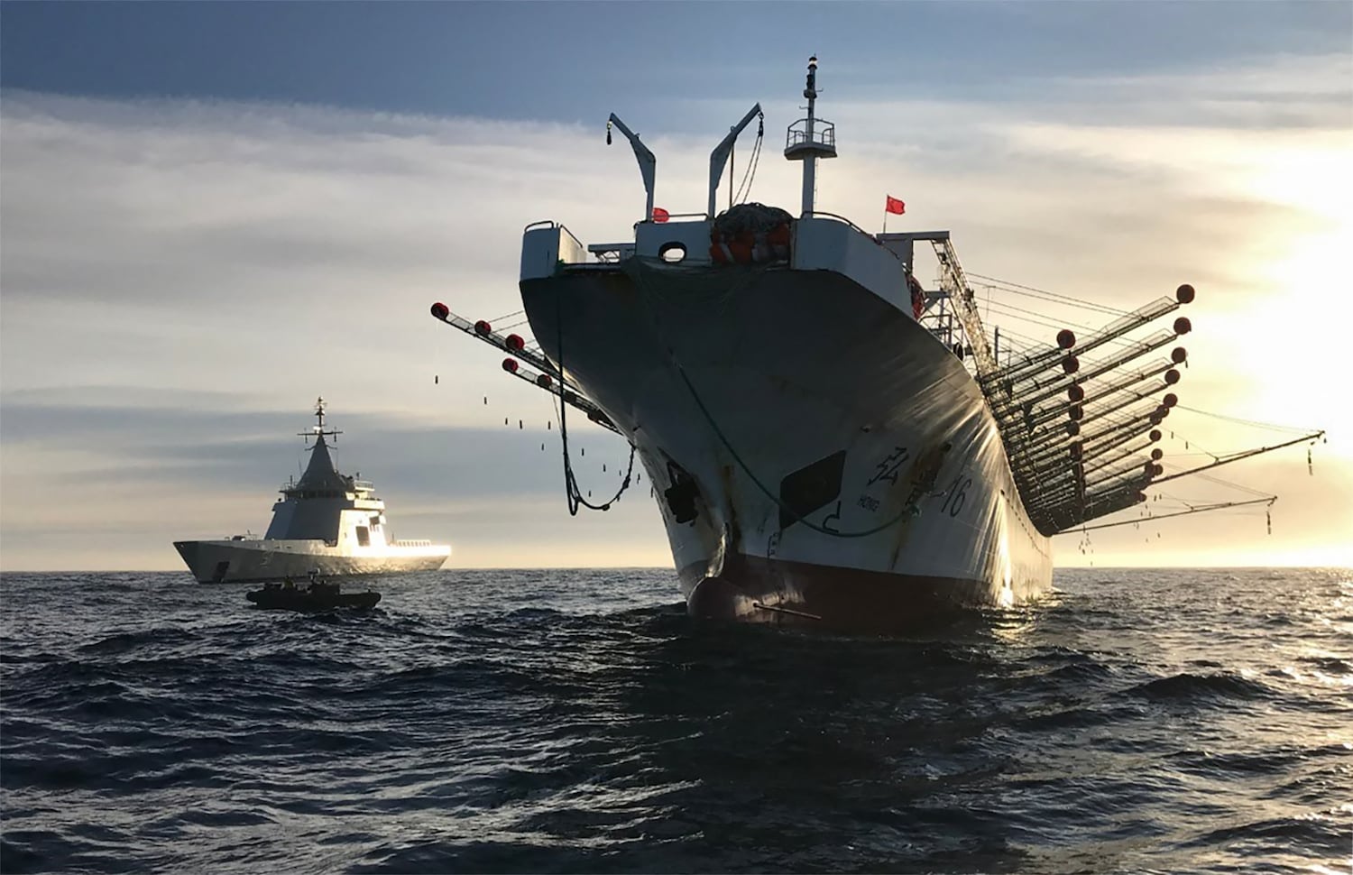 An Argentine navy patrol vessel escorts a China-flagged fishing ship after it was caught illegally operating in Argentina's Exclusive Economic Zone on May 4, 2020.