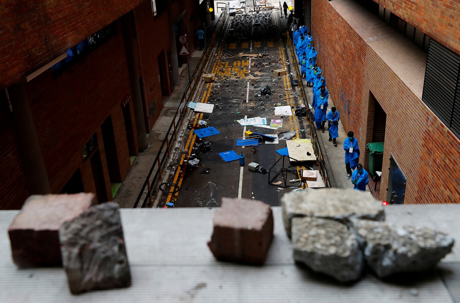 Protesters leave the Hong Kong Polytechnic University campus to surrender to police, in Hong Kong, Nov. 19, 2019.