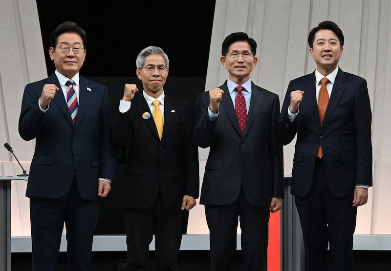 (L to R) South Korea’s presidential candidates, Lee Jae-myung of the Democratic Party, Kwon Young-guk of the Democratic Labor Party, Kim Moon-soo of the People Power Party and Lee Jun-seok of the New Reform Party pose for photographs ahead of the third televised presidential debate for the forthcoming June 3 presidential election on May 27, 2025.
