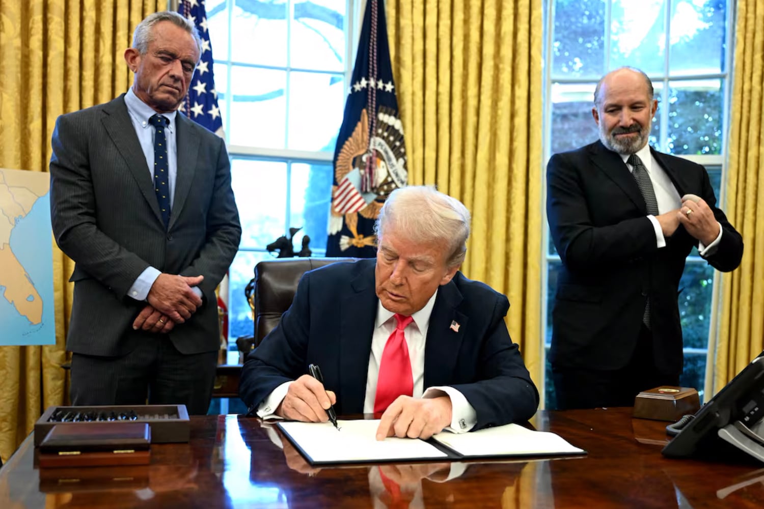 President Donald Trump signs an executive order in the Oval Office of the White House, Feb. 25, 2025.